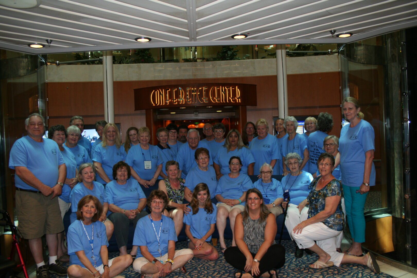 Group of people wearing matching blue shirts.