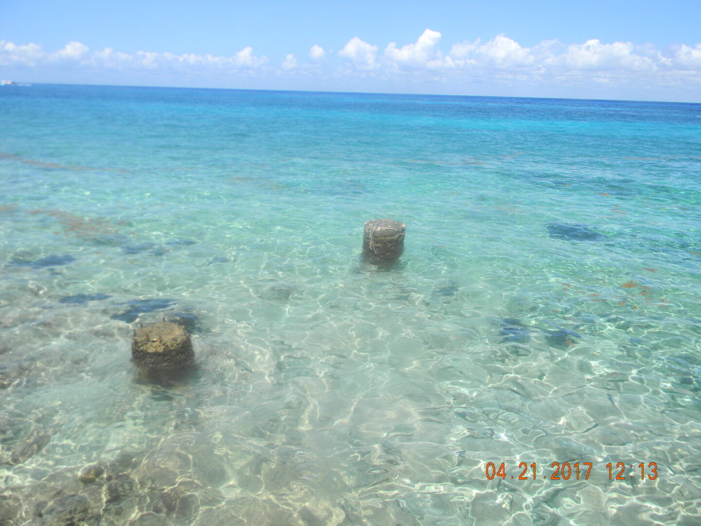 Clear blue ocean with submerged pillars.