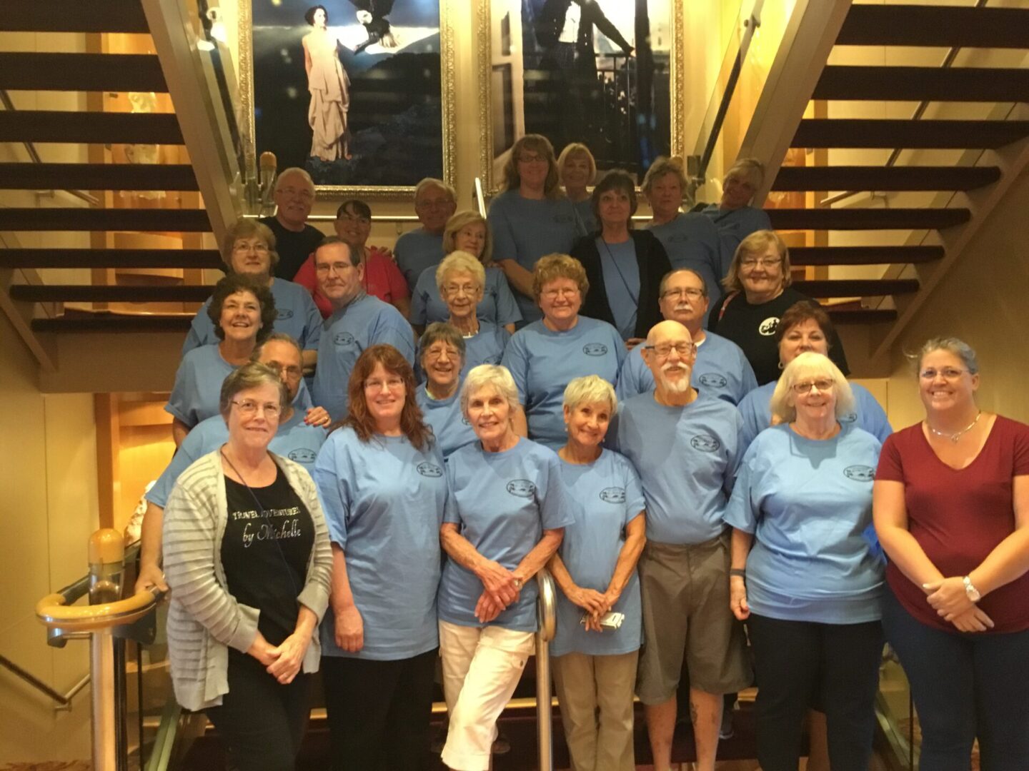 Group of people posing on staircase.