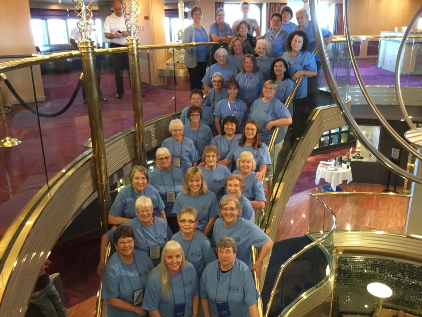 Group of people on a staircase, smiling.