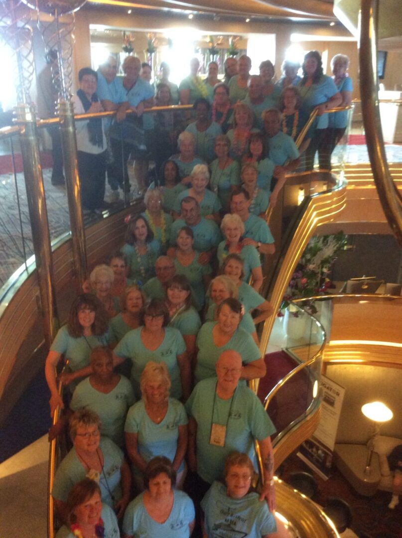 Group on staircase wearing matching blue shirts.