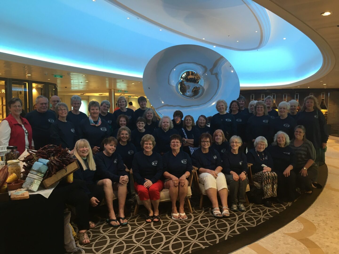 Group of people in matching shirts indoors.