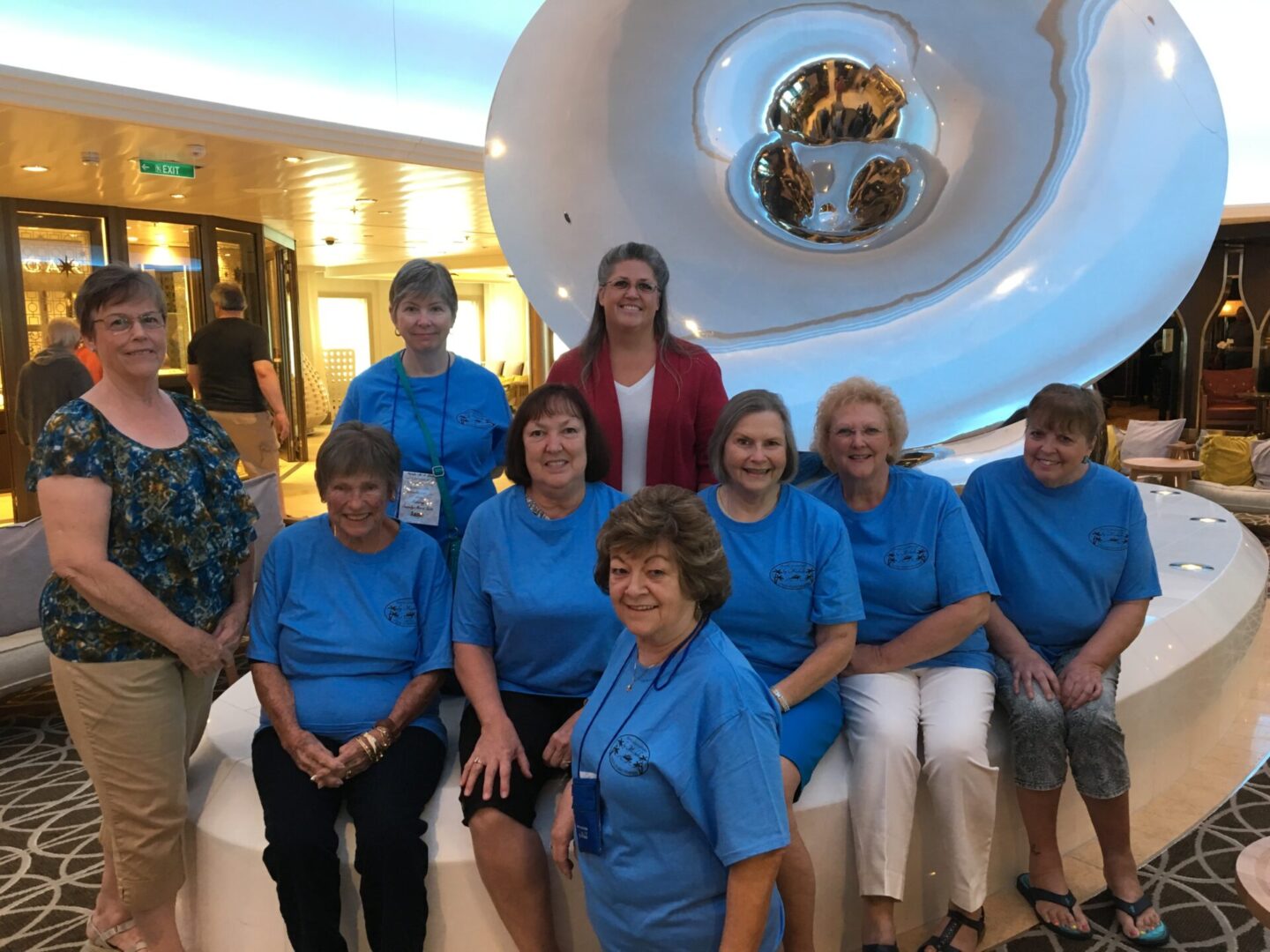 Group of women posing in matching shirts.