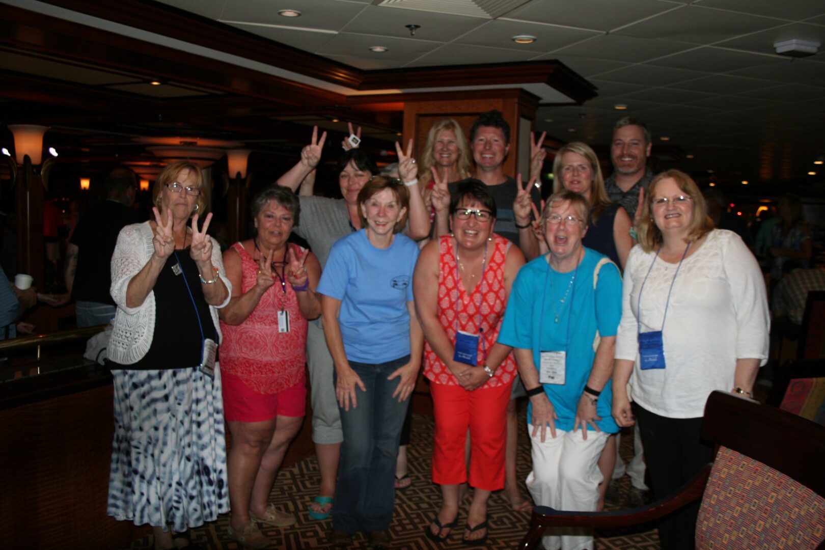 Group of people posing indoors, smiling together.