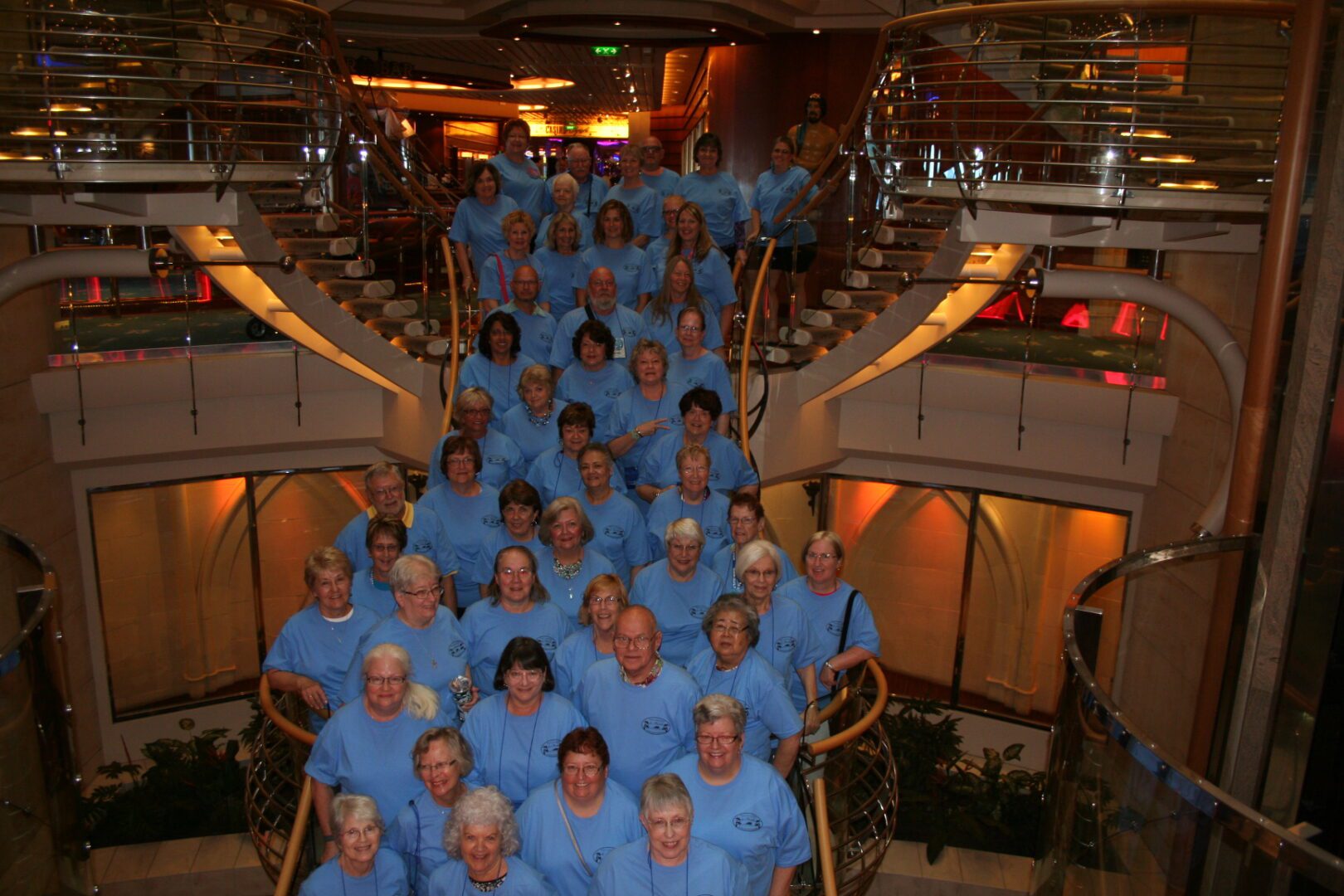 Group of people in matching blue shirts.