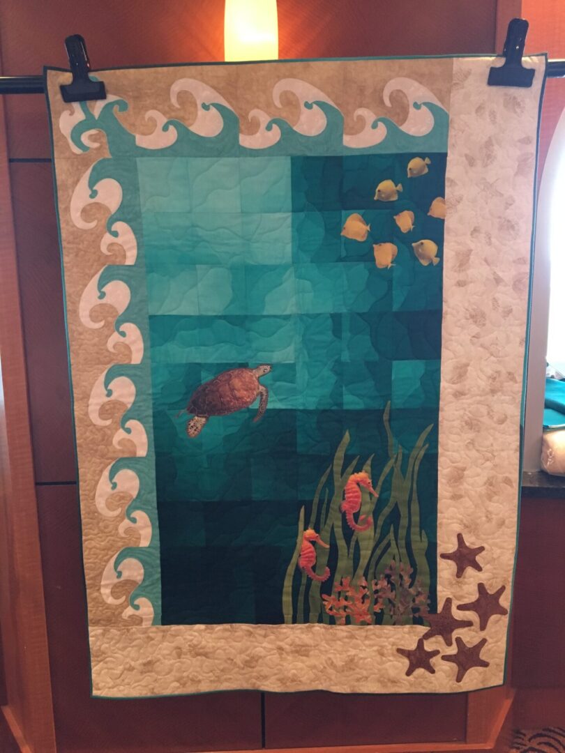 Quilt with ocean theme, featuring sea creatures.