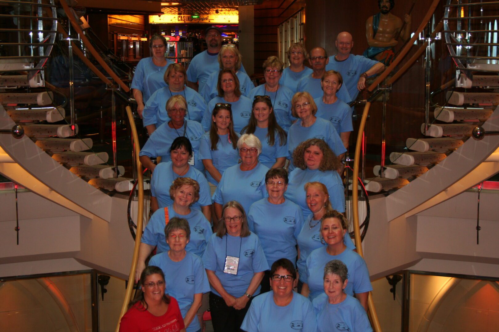 Group of people wearing matching blue shirts.