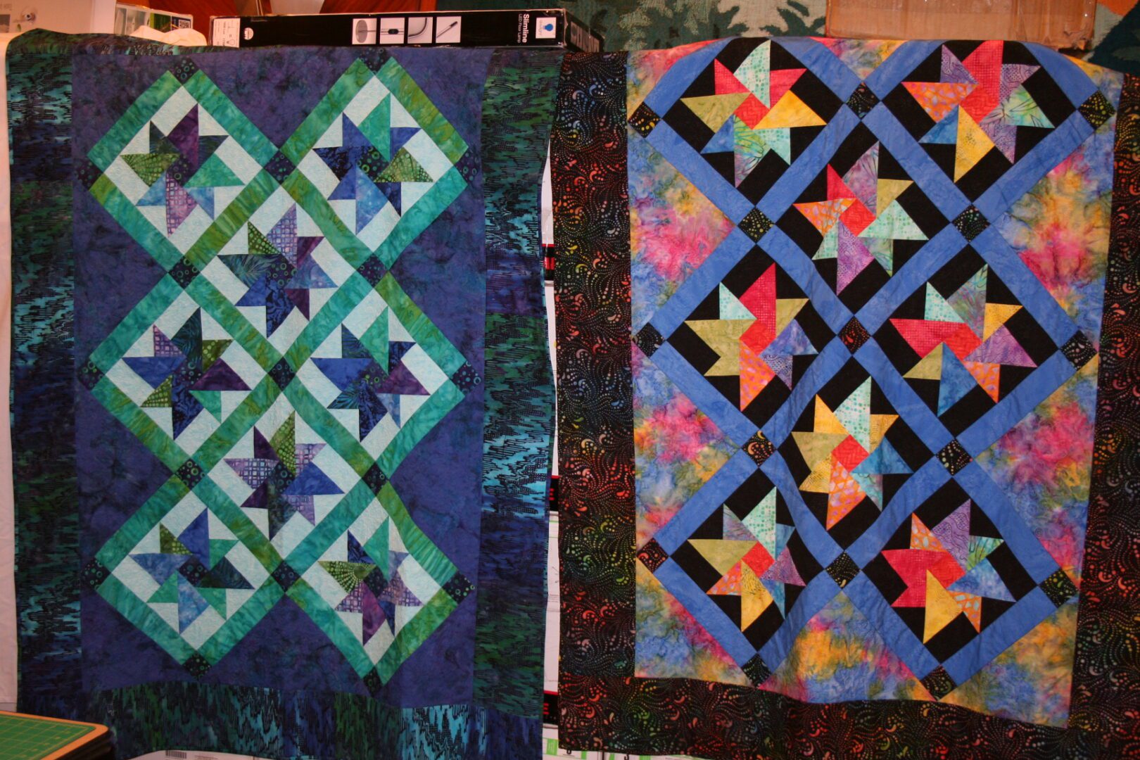 Two colorful star-patterned quilts displayed.