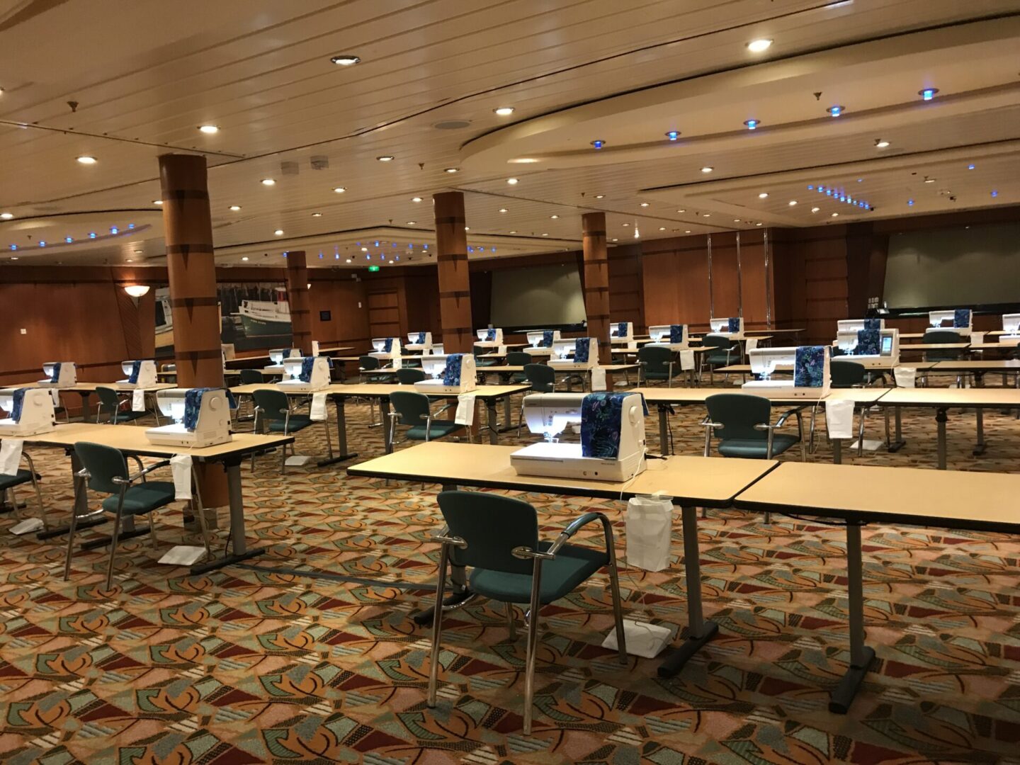 Room with sewing machines on tables.