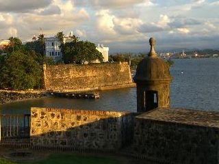 Historic fort overlooking a calm waterfront scene.