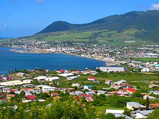 Coastal town with mountains in the background.